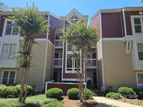Inviting multi-story condo building with well-maintained landscaping and covered entryways at 854 Southwest Dr, Davidson, NC 28036