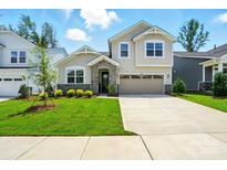 Charming two-story home featuring a stone accent entryway, well-manicured lawn, and a two car garage at 9842 Quercus Ln, Huntersville, NC 28078