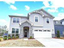 Charming two-story home with a stone-accented entryway and a two-car garage showcasing curb appeal at 9934 Cask Way, Huntersville, NC 28078