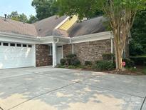 Charming home featuring a brick and stone facade, well-maintained landscaping, and a two-car garage at 10875 Casetta Dr, Matthews, NC 28105