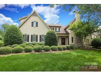 Charming exterior elevation of home with manicured landscaping and mature trees, providing a warm and inviting curb appeal at 1103 Mapesbury Ln, Waxhaw, NC 28173