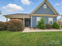 Charming blue home featuring a well-manicured lawn and inviting front porch at 11225 Island View Ln, Lancaster, SC 29720