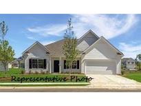 Charming single-story home with white siding, black shutters, and a well-manicured lawn under a bright blue sky at 12184 Muscadine Ct, Midland, NC 28107