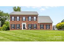 Beautiful brick home with meticulously maintained lawn and classic black shutters at 126 Rocky Trail Ct, Fort Mill, SC 29715