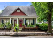 Charming home featuring a welcoming facade with dual entrances, red trim, and tasteful landscaping at 12663 Windyedge Rd, Huntersville, NC 28078