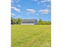Exterior of a one-story home with a long porch and a large lawn at 135 Waycross Dr, Rockwell, NC 28110