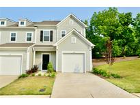 Inviting townhome featuring a well-manicured lawn and an attached one-car garage, providing both curb appeal and practicality at 1365 Eagle Claw Dr, Kannapolis, NC 28083