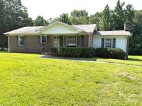 Charming single-story home with a well-maintained lawn and mature trees at 1460 Legion Rd, Fort Mill, SC 29715
