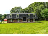 Charming home featuring a landscaped front yard and a classic mansard roof design at 1867 Shannon Dr, Conover, NC 28613