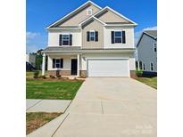 Charming two-story home with a spacious two-car garage, manicured lawn, and traditional design at 2199 Catawba Trace Dr, Catawba, NC 28609