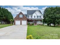 Charming two-story brick home with a well-manicured lawn and two-car garage at 2779 Touchstone Cir, Newton, NC 28658