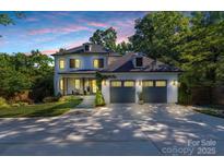 Beautiful two-story home with a three-car garage and manicured front yard at 4211 Tangle Dr, Charlotte, NC 28211