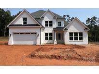 Charming two-story home featuring a white brick facade and a spacious two-car garage at 4622 Serenity Woods Ct, Charlotte, NC 28216