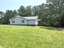 Charming single-story home with light blue siding and well-maintained lawn at 5410 A R Gordon Rd, Waxhaw, NC 28173