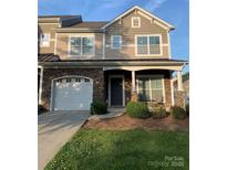 Charming two-story home with stone accents, a white garage door, and a welcoming front porch at 6333 Cory Bret Ln, Charlotte, NC 28278