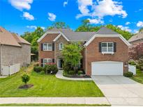 Beautiful two-story brick home with a manicured lawn and an attached two-car garage at 8460 Fairgreen Ave, Waxhaw, NC 28173