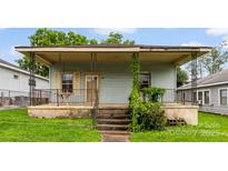 Charming home featuring a cozy front porch with decorative railings, perfect for relaxing outdoors at 92 E Spencer Mountain Ave, Gastonia, NC 28054