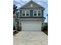 Charming two-story home featuring a two-car garage and blue and gray siding at 15208 Caspian Way, Charlotte, NC 28278