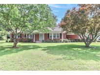 Charming brick home with a well-maintained lawn and mature trees at 158 Jane Sowers Rd, Statesville, NC 28625