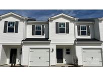 Charming townhome with white siding, black shutters, and a one-car garage, showcasing modern curb appeal at 1750 Old Rivers Rd, Concord, NC 28027
