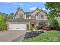 Charming two-story home with a stone-accented facade, two-car garage, and inviting landscaped front yard at 1849 Still Water Ln, Indian Land, SC 29707