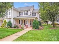 Charming two-story home with black shutters, a covered porch, and a well-manicured lawn at 2065 Gable Way Ln, Matthews, NC 28104