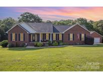 Charming one-story brick home with black shutters, manicured lawn, and an inviting front porch at 214 Silver Creek Ln, Shelby, NC 28152