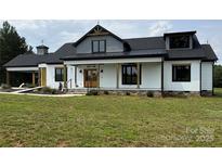 Charming two-story home with white siding, stone accents, and a covered front porch at 2410 Charlotte Hwy, York, SC 29745