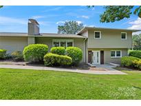 Charming two-story home with a well-maintained lawn and mature landscaping at 245 Enwood Dr, Charlotte, NC 28214
