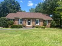 Charming brick ranch-style home featuring a lush green lawn and beautifully manicured landscaping, located on a tree-lined street at 2592 Tully Ct # 78, Lancaster, SC 29720