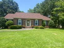 Charming brick home featuring a well-manicured lawn and inviting front entrance with flowers at 2592 Tully Ct # 78, Lancaster, SC 29720