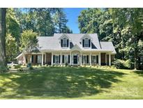 Charming single-story home with brick accents, shutters, and a spacious front lawn at 390 Robinson Rd, Mooresville, NC 28117