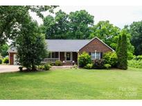 Charming brick ranch-style home featuring a well-manicured lawn and an inviting front porch at 400 Majolica Rd, Salisbury, NC 28147