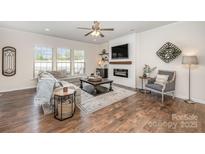 Comfortable living room featuring a modern fireplace, large sectional sofa, and stylish decor at 4012 Woodsmill Rd, Fort Mill, SC 29707