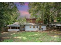 Expansive backyard featuring lush greenery and mature trees offering privacy and shade for outdoor enjoyment at 417 Phifer Rd, Kings Mountain, NC 28086