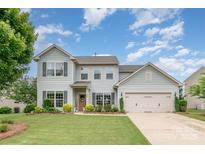 Charming two-story home with a manicured lawn, an attached two-car garage and delightful landscaping at 5092 Nighthawk Dr, Indian Land, SC 29707