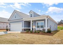 Charming single-Gathering home features a well-manicured lawn and inviting front porch at 523 Hullview Vis, Monroe, NC 28110