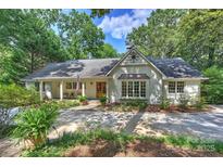 Charming single-story home featuring a welcoming front porch and a beautifully landscaped front yard at 6741 Folger Dr, Charlotte, NC 28270