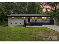 Charming exterior of this ranch style home featuring a covered front porch and freshly painted brick and siding at 704 W Border St, Dallas, NC 28034