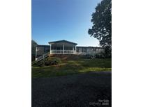 Charming single-story home with a welcoming front porch and manicured landscaping at 7225 Landsford Rd, Monroe, NC 28112