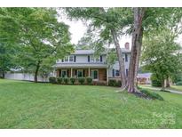 Charming two-story home with brick and siding, a covered front porch, and a well-manicured lawn and mature trees at 734 Forestbrook Dr # 10, Gastonia, NC 28056