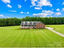 Beautiful brick home featuring a lush green lawn and a welcoming front porch at 106 Laren Rd, Shelby, NC 28152