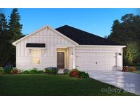 Charming single-story home featuring a classic white facade, inviting front yard, and attached two-car garage at 1205 Morehead Dr, Salisbury, NC 28144