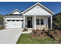 Charming single-story home featuring a well-manicured lawn, attached two-car garage, and a welcoming covered porch at 1205 Morehead Dr, Salisbury, NC 28144