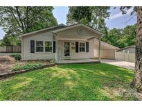 Charming single-story home featuring a cozy front porch and well-maintained lawn at 267 Buffalo Nw Ave, Concord, NC 28025