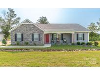 Charming single-story home featuring stone accents, a welcoming front porch, and a well-maintained front yard at 2737 Bobcat Rd, Heath Springs, SC 29058