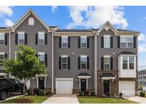 Charming gray townhouse featuring a one-car garage and a well-maintained front lawn at 3108 Beeler Ln, Charlotte, NC 28208