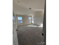 Bright and airy bedroom with plush carpeting and large windows, providing ample natural light at 3244 Oulten Sw St, Concord, NC 28027