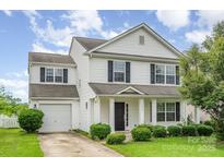 Charming two-story home with a well-maintained front yard and a one-car garage at 3244 Oulten Sw St, Concord, NC 28027