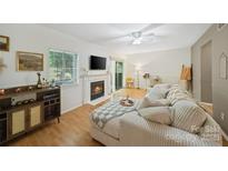 Cozy living room with fireplace, TV, and comfortable corduroy sectional sofa at 3737 Winding Creek Ln, Charlotte, NC 28226